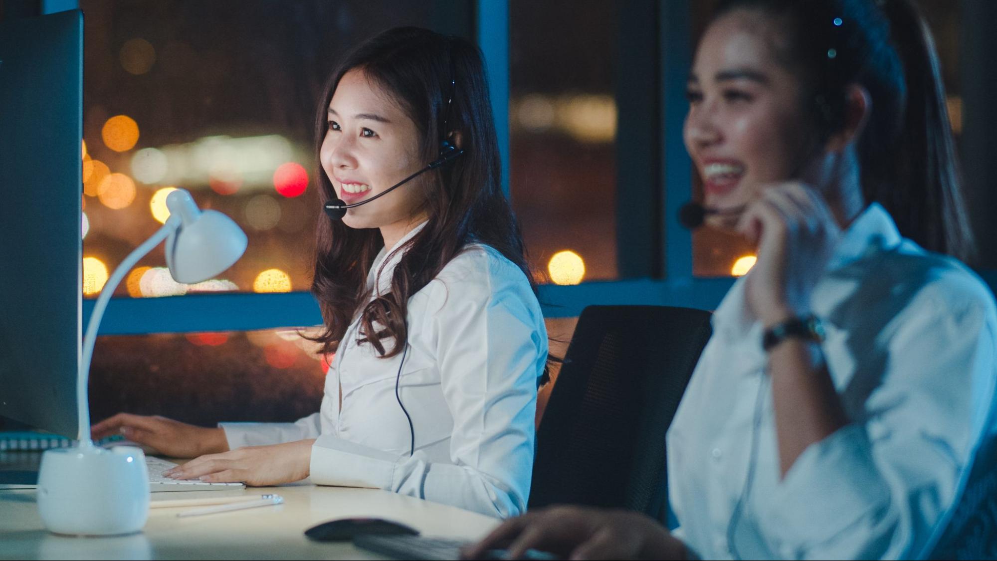 Customer support agents using headsets in a modern AI-powered contact center during operations