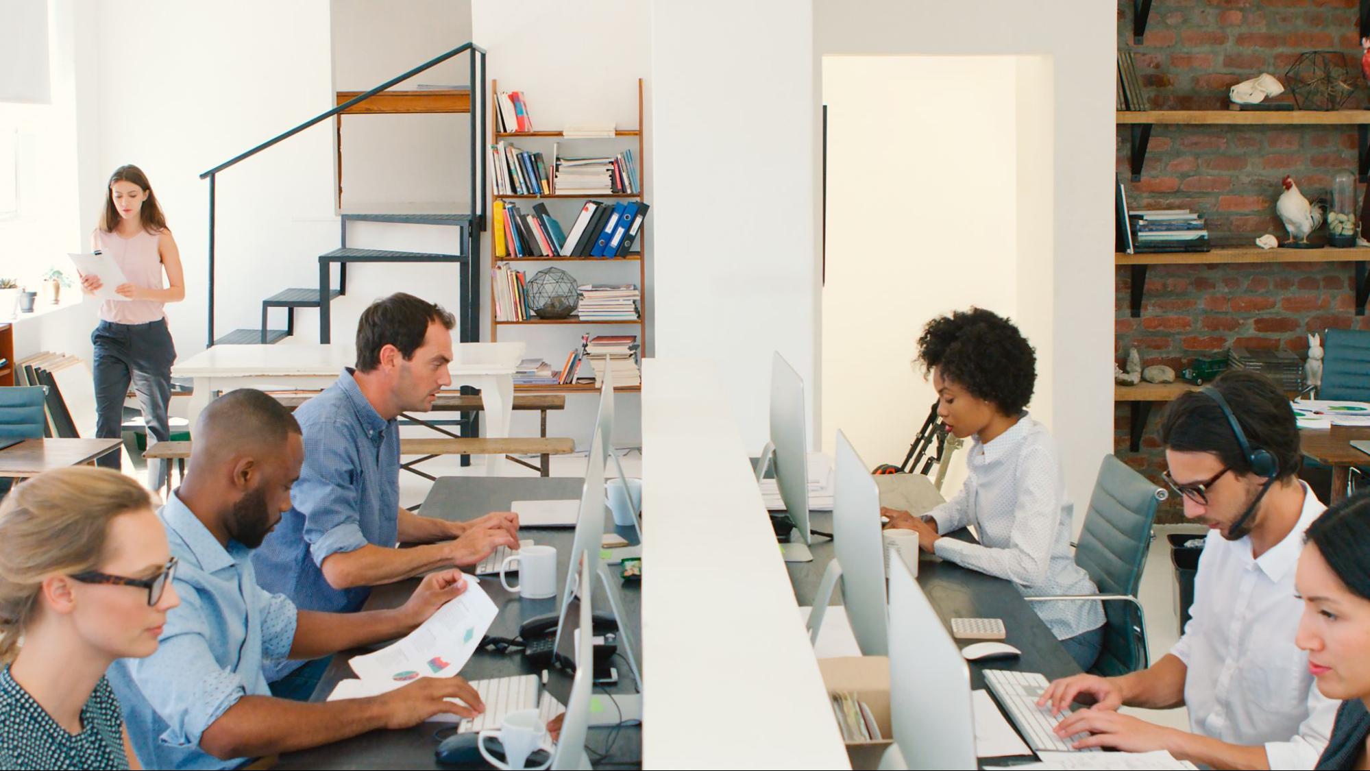 Multicultural business team working together in a modern office on digital marketing projects